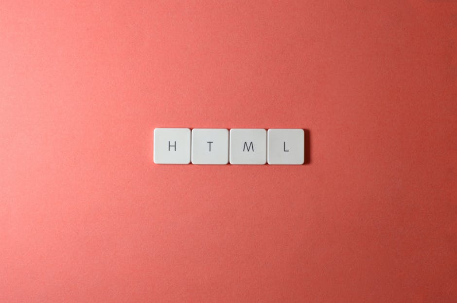 Close-up image showing four white square tiles arranged in a horizontal line on a coral-pink background. Each tile has a black letter printed on it, spelling out the abbreviation 'HTML.' The tiles are